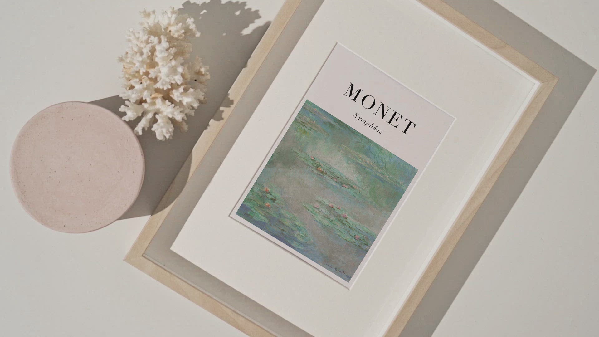 Monet painting of water lilies with the artist name and title of the work in black font.
